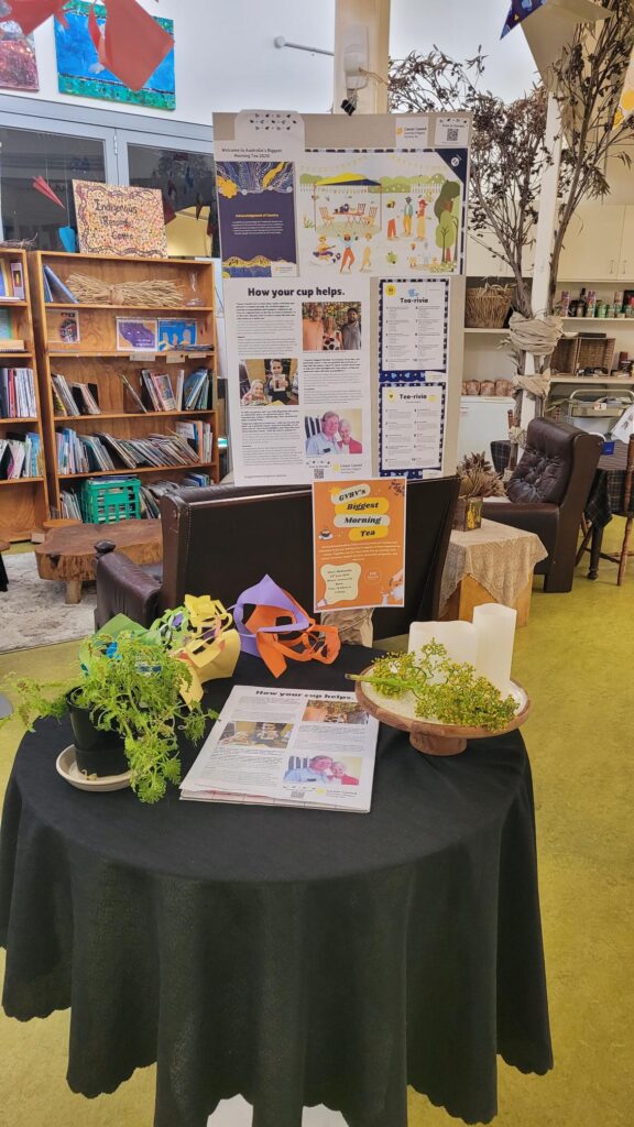 A display with signs, information, plants and artwork