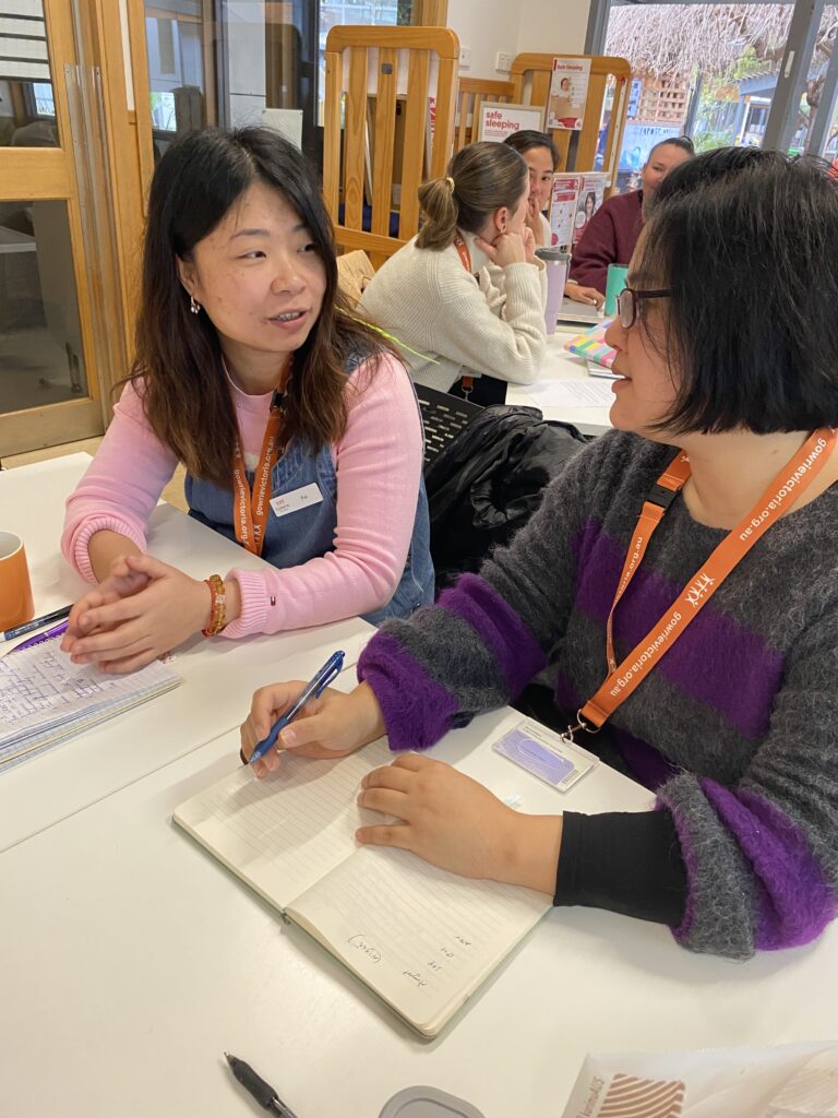 Two mentors are sitting together having a discussion