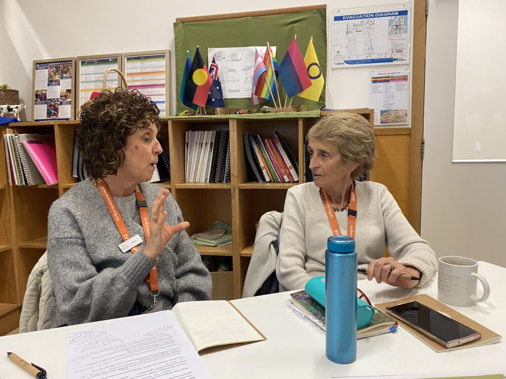 Two mentors are sitting together having a discussion