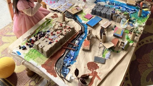 Children build a Melbourne landscape using loose parts.